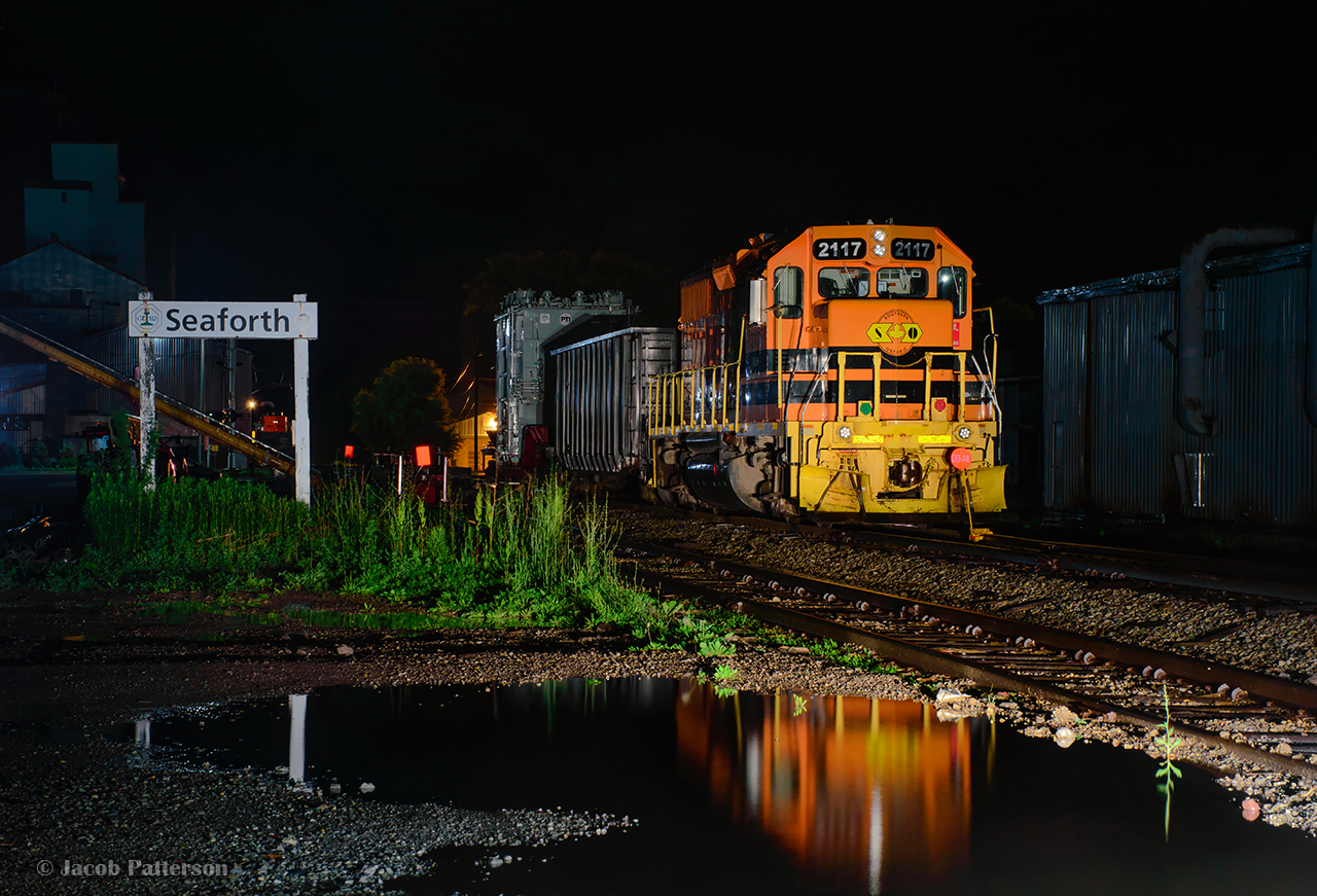Getting off work in the middle of the night, a drive to Seaforth was in order.  Earlier in the day, a friend had mentioned seeing GEXR 3523 tied down next to Seaforth Elevators.  Taking a chance, 3523 was indeed parked there, seen beyond the name sign, but north of Main Street was the main subject.  GEXR 581 is tied down on the Goderich Sub main, where Mammoet crews have spent the previous day preparing equipment to transload a large transformer for Hydro One.