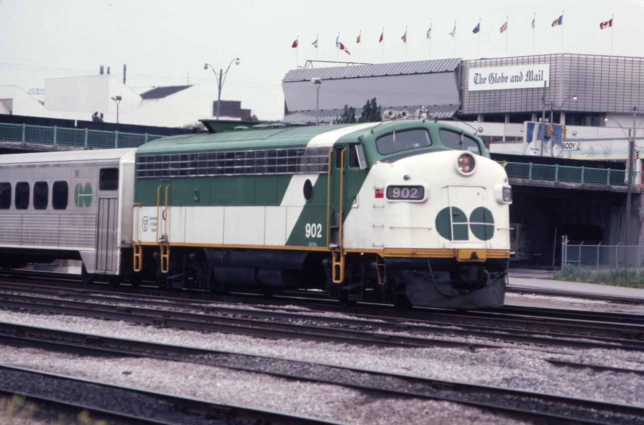 This photo from July of 1982 shows an inbound GO Transit train near the west end of Toronto Union Station, passing the Globe & Mail building. This was back when newspapers were still a thing. The leader - 902 - is a rebuilt FP7, originally Ontario Northland 1507, and is serving as an Auxiliary Power Control Unit (APCU) used in push-pull service. The unit was scrapped in 1995. After signing a release, Toronto Union Station was "Train Disneyland" for me as a 16-year-old kid.