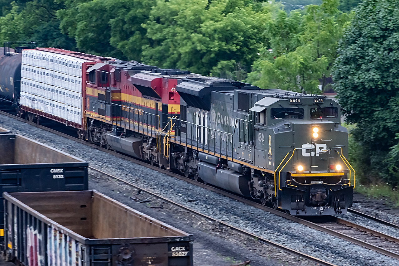 There are some units that simply mean something more. The Tuscan and Red Heritage fleet usually tops the list, but 6644 is the pinnacle. D-Day is the most important day on the planet in the last 100 years. What that day was like for those who participated still staggers the imagination. So of all CP's military units, this one holds special significance with its iconic D-Day stripes. 

2-231 was noticed leaving Montreal yesterday. Those trains can go north or west at the whim of the railroad, so you never know. Waking at "sunrise" and hoping for a cloudy day revealed a westbound at Guelph Junction. Could it have fallen back enough to be it arriving in some form of daylight...and where to get it? 

I offer my best shot to date of 6644 leading an all GM lashup, which itself is pretty rare, passing under Dundas St. in Galt. It's nice when all the pieces fit together.