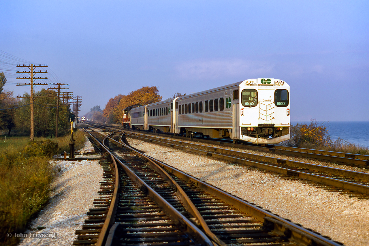 GO Transit cab car 9852 brings up the rear of an eastbound GO train approaching the relatively new Rouge Hill GO station, where a westbound led by cab car 9830 is making its stop.  CN's former Port Union station can barely be seen at left between the far GO train and the switchstand, last serviced circa 1967, and demolished in 1972

Scan and editing by Jacob Patterson.