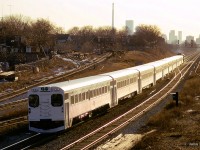 Golden sun glistens off aluminum, single level cars as an eastbound train for Pickering approaches Danforth station.  GMD GP40TC 9806 pushes on the rear.

<br><br><i>Scan and editing by Jacob Patterson.</i>