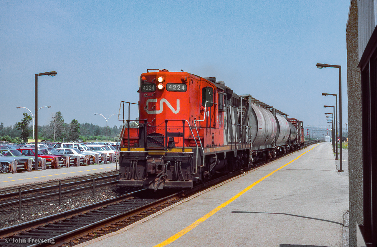 Likely returning to Belleville after working customers to the east, GMD GP9 4224 leads a local westbound through Kingston.

Scan and editing by Jacob Patterson.