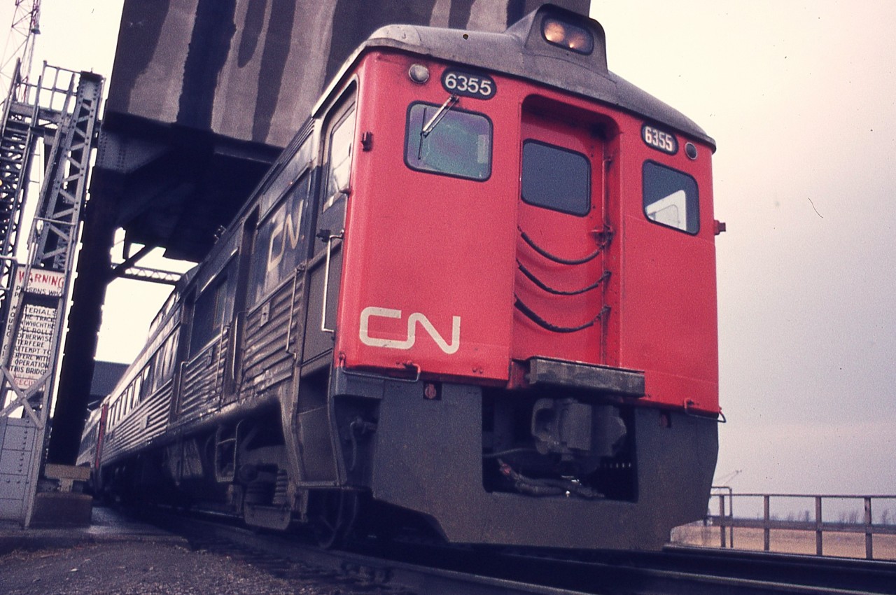 Back when I could still drive up to the tracks on the east side of the Welland canal, past the big GM plant, I would wander around a bit in hopes of seeing some rail traffic, which back then, was reasonably frequent.
Got caught out of position, so to speak, as the CN Railiners came roaring along, bound for Niagara Falls, and I had to shoot up the grade at them, right at the Welland Canal bridge.  Interesting angle, to say the least.
Budd RDC-3 #6355 was a baggage car as well has having seating for 48. It was rebuilt in 1981 as an RDC-2. I still think these were one of the most practical ideas for efficient passenger operations on the secondary lines.  Miss them.