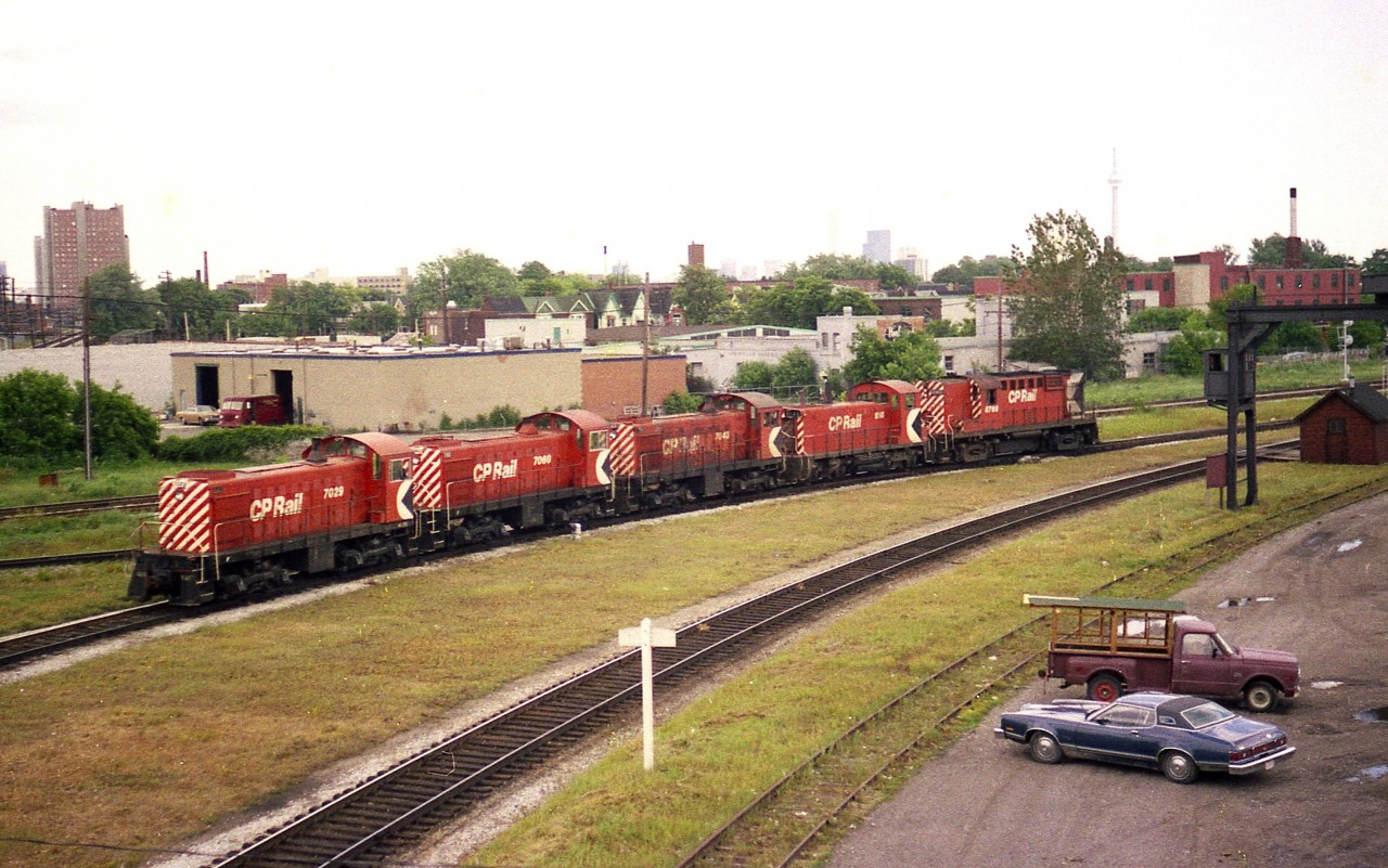 A 5 unit CP power move heading westbound over the Galt sub on a hazy late spring morning. The scene is by the old West Toronto diamond, just out of sight on the left.  Interesting collection of oldies: Three ALCO RS-2 units 7029, 7060, 7043 lead SW1200RS 8146 and last, looking rather impressive against the others, MLW RS-18 8768.
The RS-2s were gone from the roster by 1986.