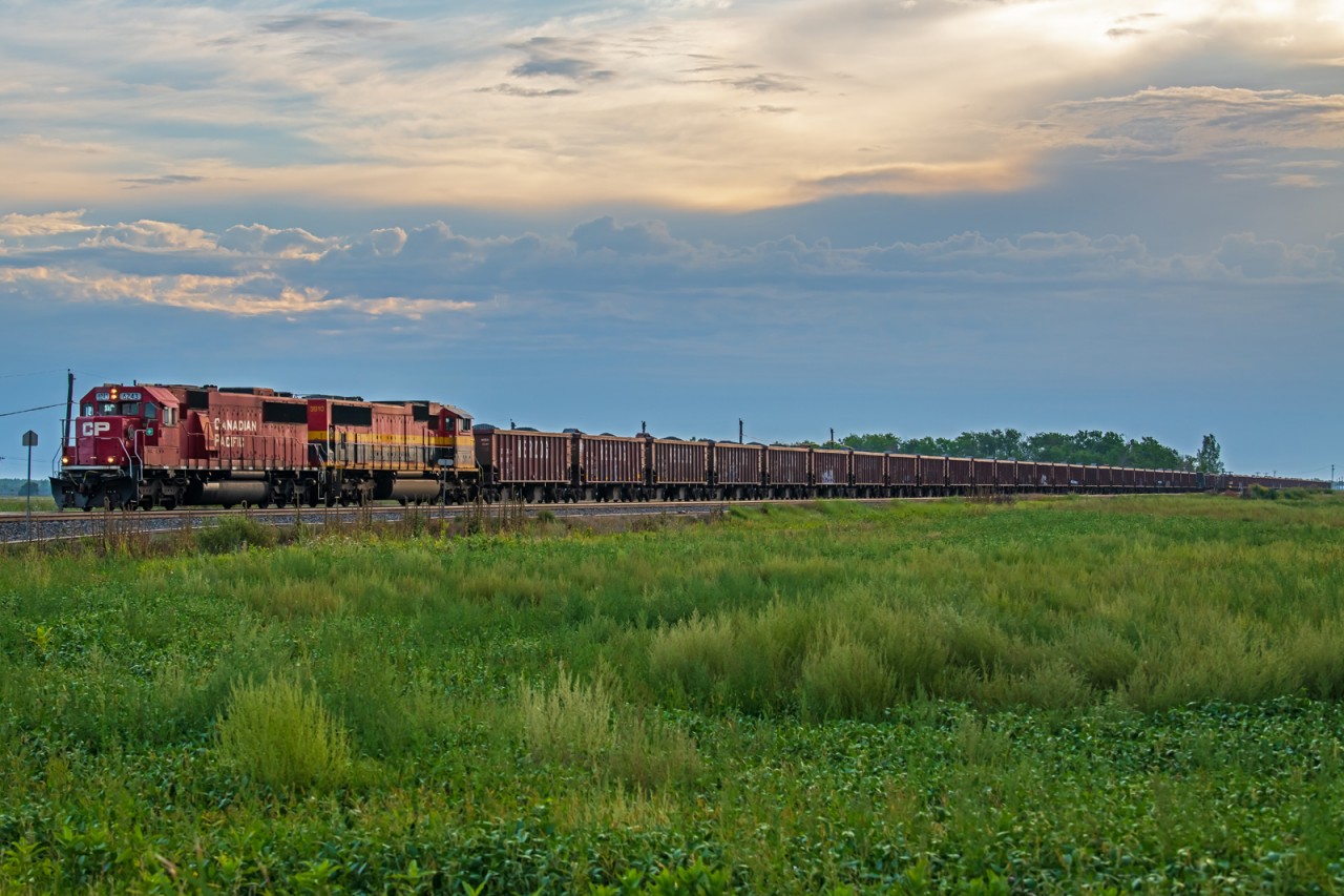 A fully loaded ballast train heading across the Manitoba prairies on their way into Winnipeg.