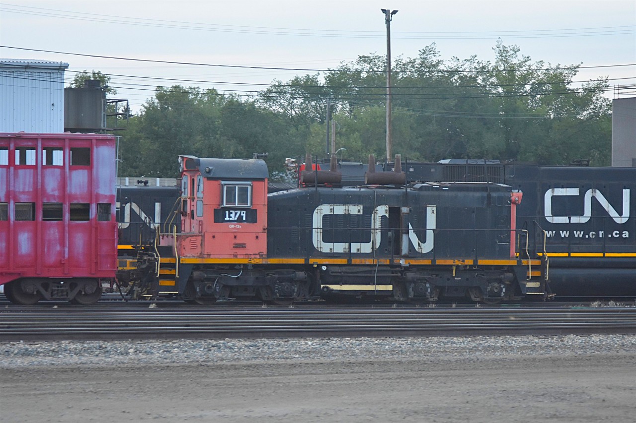 Still hangin' around  
CN 1379 Class GR-12y SW1200 is still sitting dead outside CN's Walker Yard diesel shop in Edmonton, AB on August 1, 2025. 
It hasn't moved too far from this spot over the last few years.