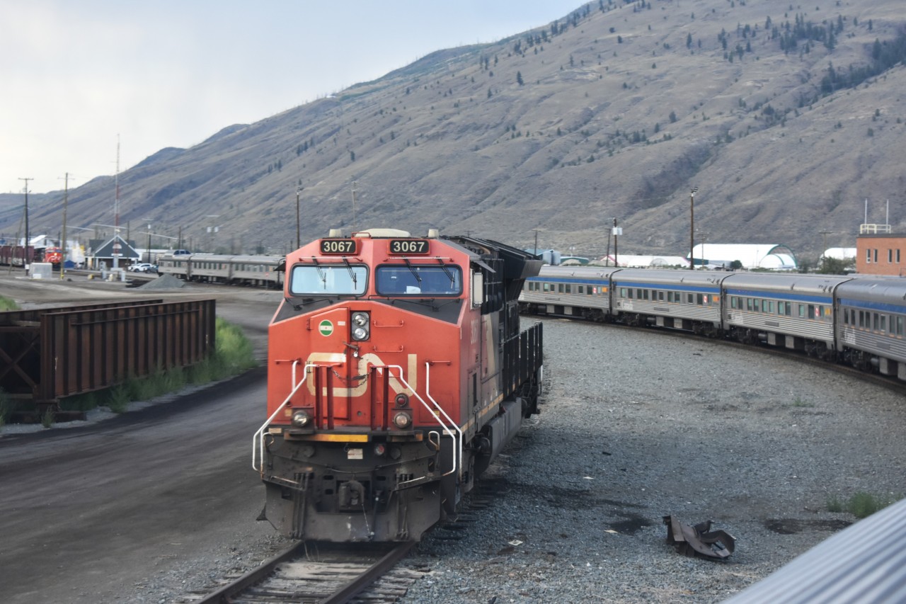 <b< Circle the Wagons  
VIA 001 The Canadian departs Kamloops, BC and the consist arcs around an idle CN 3067 parked just west of the station. 
In the background, a CN mixed freight waits patiently in the yard, soon to depart behind the much speedier passenger train. 
Another great trip on 'The Canadian' will soon be over as we will arrive in Vancouver 4-hours early the next morning.