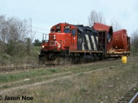 CN 580 with GP9RM 4115 is viewed approaching the Concession Road crossing in Cambridge, Ontario after lifting a loaded bulkhead car from the Babcock & Wilcox facility on the Fergus Subdivision. The crew had just set-off an empty flat car at the plant and were heading to continue switching industries on the Galt Industrial Spur in Cambridge. To the bottom right is the CP Waterloo Subdivision, which paralleled the Fergus Subdivision here to the CN Finnigan sign near Hespeler Road. 