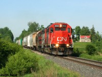 CN L542 with 4936 and 4131 are viewed approaching the Woolwich-Guelph Townline crossing on the Guelph Subdivision, situated east of Kitchener, as it heads for XV yard in Guelph. Later that morning, L542 would traverse the Fergus Spur to Cambridge with one loaded bulkhead car for Gillies Lumber. 