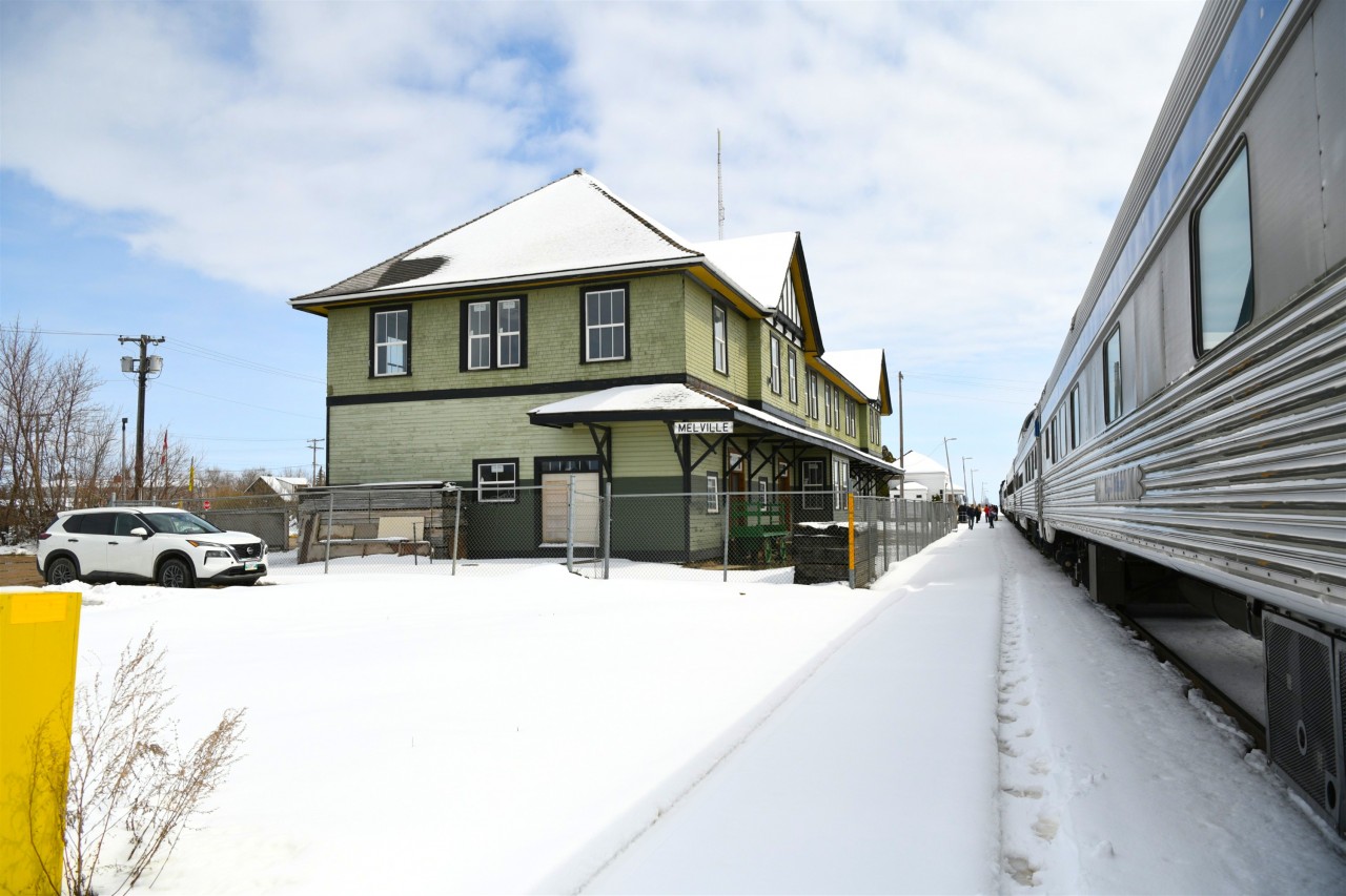 Watch Your Step  
VIA 002 is making its station stop in Melville, SK shortly after a surprise late spring snowfall. The platform has yet to be cleaned making for a sloppy and slippery walk for the few that chose to detrain. 
Restoration work continues on the classic CN station.