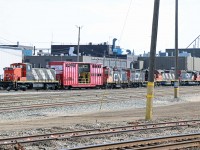 Having arrived from Winnipeg on yesterday's 317, retired GMD1u 1423 sits on the west side of the Walker Yard diesel shop accompanied by a Test Car, SW1200RS 1375? (retired in 2006), GP9rm 7001 (retired in 2009), SD38-2 1653, and SD40u 6012. 1423 was the first GMD1 built (number 1000, in 1958). Its last assignment was in Prince George in March 2001 before being used at CN's Transcona training centre. At this time, I don't know why the 1423 is "on the move".
