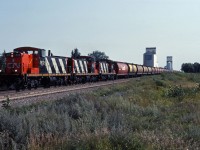 GMD1u 1612 leads sisters 1600 and 1601 west over the Rivers sub with a train of covered hoppers for loading at country elevators. Unfortunately, Oakville's elevators and the GMD1s as well as most of the "Trudeau hoppers" are now gone...