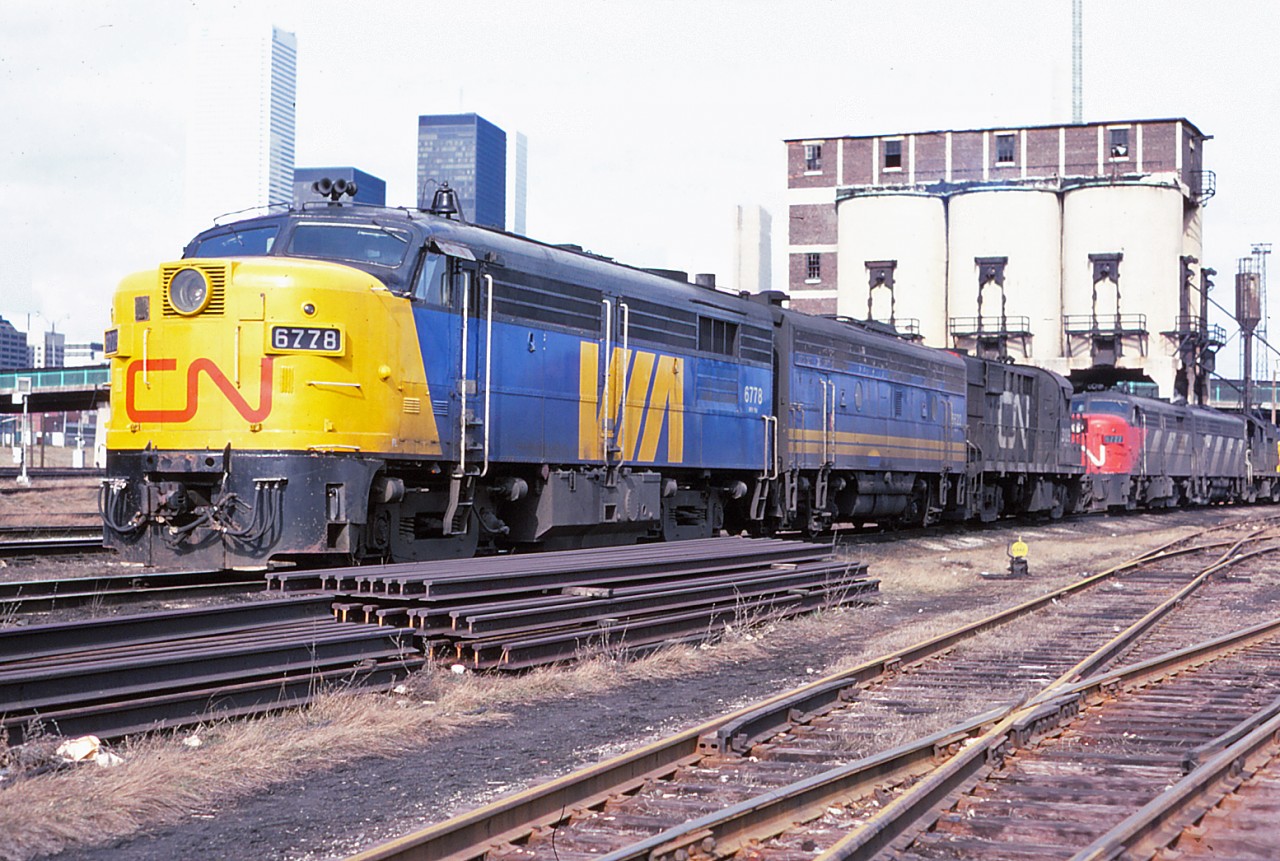 It's the spring of 1978 and change is in the air--not just the weather, but for rail passenger service in Canada. VIA Rail Canada is no longer a subsidiary of CN (1 April 1978) and has acquired CN's passenger equipment. CP's passenger equipment and operations will be acquired by fall (28 October 1978). For now, much of the equipment operating is still in CN or VIA CN colours. And, as hard as it is to think this, by 1986 the Spadina roundhouse and coach yard will have closed. Savour this moment--it won't last for long. Power in the photo: FPA4 6778, F9B 6622, RS18 3109 with FPA4 6777, another F9B and RS18 in the distance.