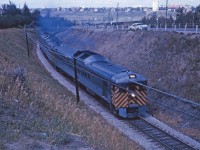 Having just crossed the high level bridge, a southbound CP Dayliner approaches its South Edmonton station stop in the summer of 1964. Based on the sun angle, this looks like No. 306, one of three daily trains in each direction between Alberta's two largest cities. No. 306 departed CP's downtown Edmonton station at 6:00 PM, arriving Calgary at 9:30 PM after a 193.9 mile run. Service was cutback to South Edmonton on October 29, 1972 and VIA service was discontinued on October 27, 1985. 