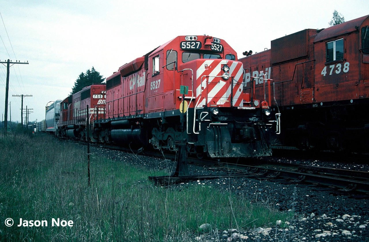 A westbound CP train powered by SD40 5527 and SOO Line SD40-2 758 are taking the siding at Blandford, Ontario on the Galt Subdivision as they meet 510 waiting on the mainline. Train 510’s consist included SD40 5549, M-636 4738, SD40 5562, HATX GP40 520 and SD40-2 762. Later that same month, M-636 4738 would be retired for good on May 24 and eventually scrapped.