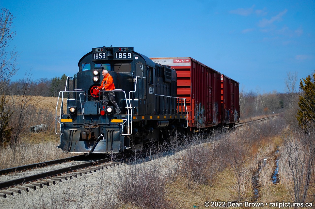 TRRY RS18u 1859 heads northbound approaching Port Robinson Rd. on the Canal Sub heading back from St. Catharines and are on their way back home to Welland.

The conductor has to flag the crossing at Port Robinson because the crossing Protections are out of service.