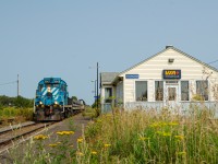 To help fighting coastal erosion, the provincial government allocated a 25 Million dollars contract to replenish the beaches in the small town of Maria, in eastern Quebec. To help fighting vehicular traffic on Route 132, the railway was chosen to carry the crushed stones from a quarry in Nouvelle, to the beaches of Maria. These operations consists of about 6 round trips a day. One with a train made of 7 Diffco side-dump cars and one locomotive at each end, and another made of multiple modified 2-bay cement hoppers, four ex-UP ballast cars along with 2 locomotives at the head end and one at the rear end, in order to return the empty train back to Nouvelle. This longer train only operates twice a day, once in each direction.
These operations should last until December 2025, and they make for a nice opportunity to catch SFG's fleet of RS18us, as a large part of their roster is needed to conduct these operations.
In this picture we can see one of the empty return trips of the shorter train, led by RS18 #1849 and ending with HLCX 1069, passing by the old VIA Rail Carleton station. It has been abandonned since VIA Rail discontinued the Chaleur trains, due to the line past of New Richmond being in disrepair. It is unknown when service will resume.