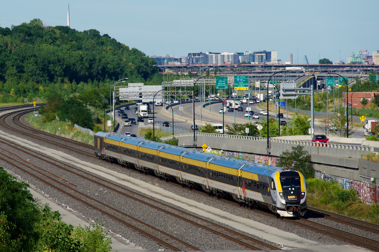 With CN imposing crossing-related speed restrictions on the standard 24-axle VIA Rail Siemens consists on any lines that it owns, VIA Rail has started adding two more cars to two consists so far (CN has no restrictions on Siemens consists of 32 axles or greater). Here VIA 37 with 32 axles is approaching Turcot Ouest.