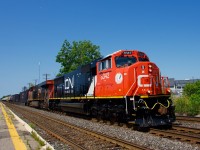 Freshly rebuilt CN 8342 leads CN 368 through Dorval, with CN 2894 trailing.