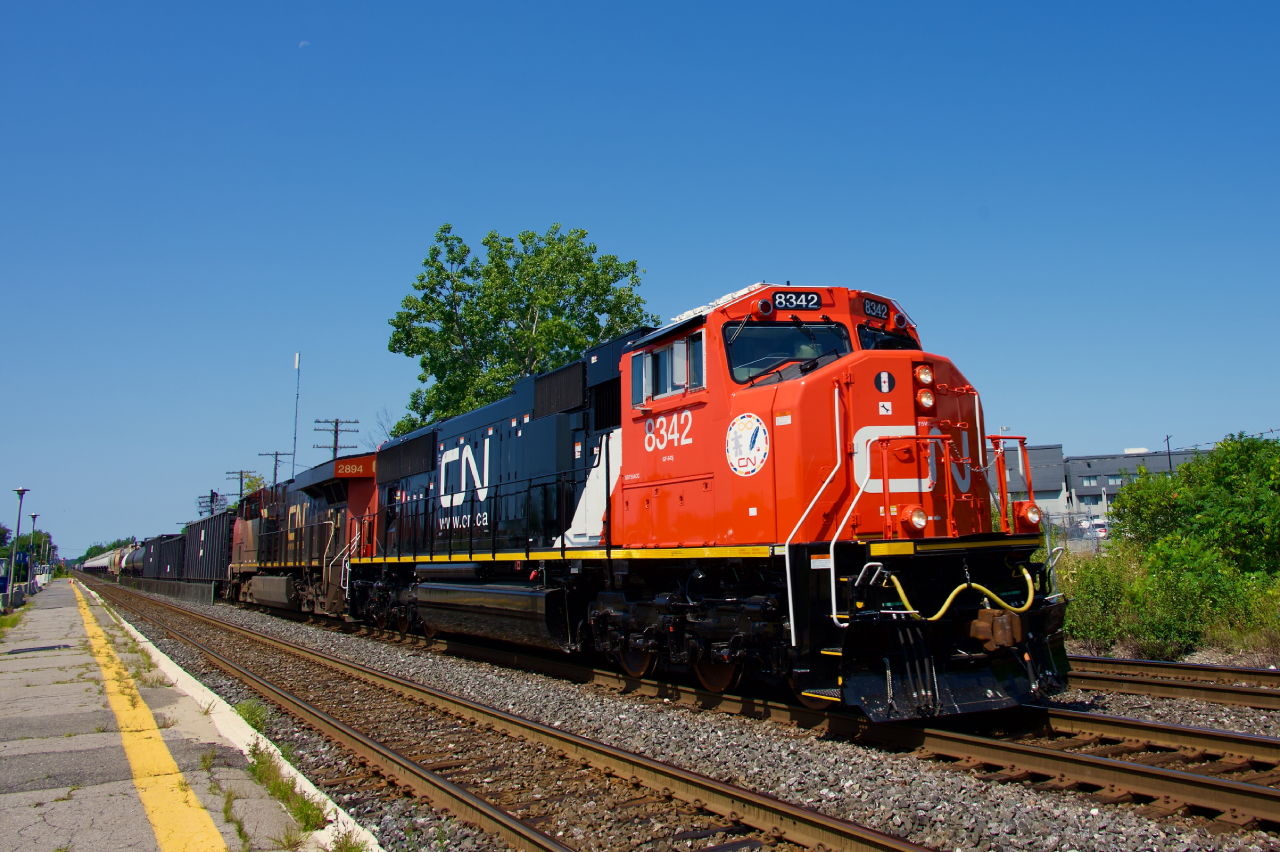 Freshly rebuilt CN 8342 leads CN 368 through Dorval, with CN 2894 trailing.