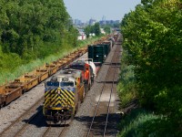 CN 527 has two dimensional loads up front as it crawls towards Taschereau Yard, probably doing all of 5 mph. Power is CN 3937 & CN 3388.
