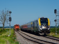 CN 589 is tucked away in the De Beaujeu siding as VIA 24 overtakes it just before it crosses the CPKC Winchester Sub at grade. A few minutes later, CN 589 will get its signal to follow VIA 24 towards Coteau.