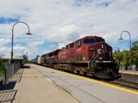 Ethanol train CPKC 528 has a CP and a KCS AC4400CW up front as it passes through the EXO Dorval Station.