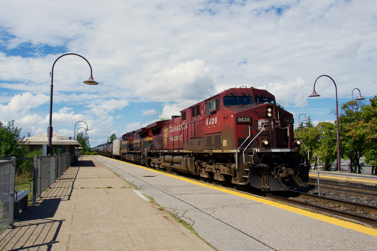 Ethanol train CPKC 528 has a CP and a KCS AC4400CW up front as it passes through the EXO Dorval Station.
