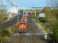CN M305 proceeds through the plant at Whitby, passing E271 in the south service track.