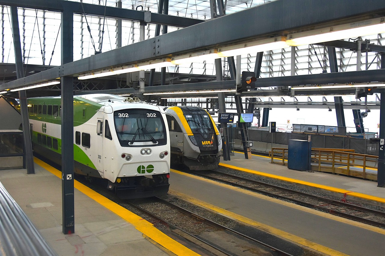 Modern Canadian Passenger Equipment at Work  
GOT 302 pulls up alongside VIA 2302 inside the Union Station train shed in Toronto, ON July 30, 2025. 
These sleek new trains are quite the contrast to the 1950's Budd built equipment on VIA Rail's 'The Canadian' that is boarding passengers on the track next to them.