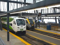 <b> Modern Canadian Passenger Equipment at Work </b> <br>
GOT 302 pulls up alongside VIA 2302 inside the Union Station train shed in Toronto, ON July 30, 2025. <br>
These sleek new trains are quite the contrast to the 1950's Budd built equipment on VIA Rail's 'The Canadian' that is boarding passengers on the track next to them.