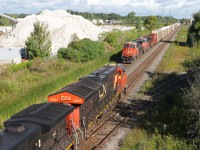 With their train stretched across the single track at Tansley (Mile 43.1) M301 is about to roll by A422 stopped on the South Track.

