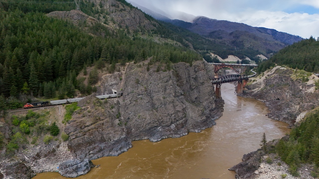 CN G 83451 21 rolls east on the CPKC Thompson Sub, as CPKC 301-230 heads west on the CN Ashcroft Sub at Cisco. 

CN G 83451 21: CN 2825, CN 2891, CN 3148 - DP 2x0x1 - 150 

CPKC 301-230: KCS 5022, KCS 4774 - DP 1x0x1 - 128 cars