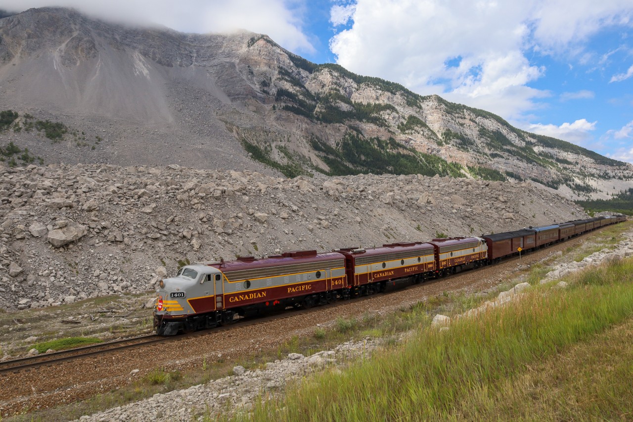 Turtle Mountain looms ominously in the distance, as the Royal Canadian Pacific navigates the debris field at Frank Slide.  In 1903, Turtle Mountain gave way, sending 110 million tonnes of rock into the valley, burying part of the town of Frank and the CP mainline.  Within 3 weeks, the CPR had reopened the line and the town of Frank was relocated away from the mountain. 122 years later the remnants of the slide provide a constant reminder of the tragedy which claimed 70-90 lives.  The unstable mountain is monitored through sensors, as there is a risk of a future slide.