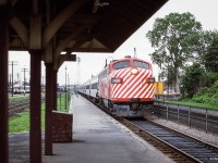 Passing the old CP Glen Yard facilities, CP 1400 brings an eastbound train to a stop at Westmount station.

<br><br><i>Scan and editing by Jacob Patterson.</i>