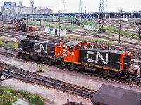 A pair of CN switchers work the Bathurst North Yard while MLW S13s work the coach yard.

<br><br><i>Scan and editing by Jacob Patterson.</i>