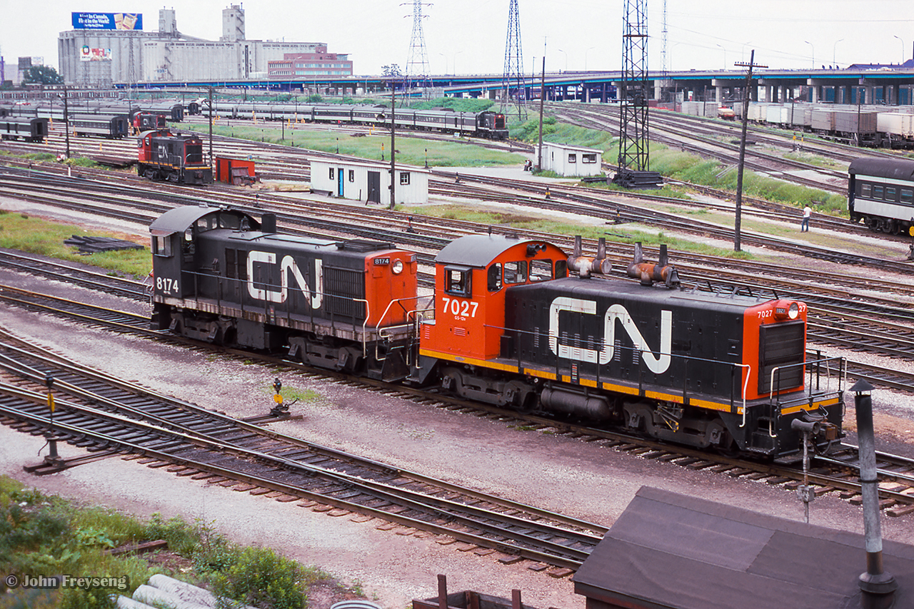 A pair of CN switchers work the Bathurst North Yard while MLW S13s work the coach yard.

Scan and editing by Jacob Patterson.