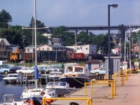 Making their evening appearance on the shared industrial trackage in Parry Sound, CP ALCO S2 7027 moves cars around on the waterfront.

<br><br>Arnold Mooney captured two CN scenes on this spur in June 1979.  <a href=http://www.railpictures.ca/?attachment_id=25148>Moving tank cars</a> from one of the three fuel dealers (Shell, Imperial Oil, and Ultramar,) and <a href=http://www.railpictures.ca/?attachment_id=47031>running around their van.</a>


<br><br><i>Scan and editing by Jacob Patterson.</i>