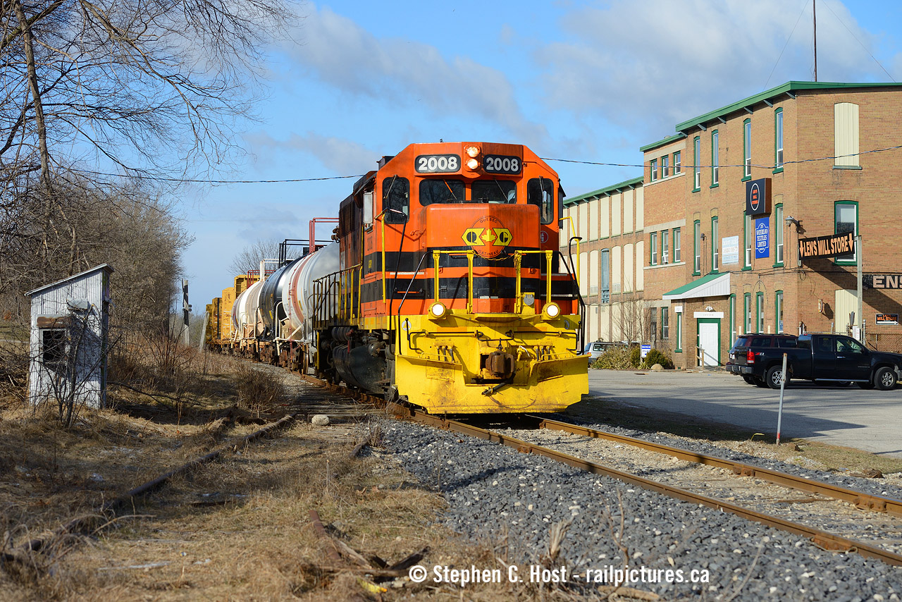 GEXR Train 582 is heading north on the former CNR Fergus sub right at the spot it used to cross the Grand River Railway in Hespeler. Operated as the R. Forbes Co. Ltd. at one time the largest woolen mill in the British Empire. The Lens mill store occupied the site at the time and had since left. What was the small grey shack used for at left? I assume it was railway. The Grand River line into Hespeler became the "Solaware" spur (Source: Comments on http://www.railpictures.ca/?attachment_id=48874 along with more information). Believe it or not, this spot would have had multiple trains per hour going back and forth from Preston to Hespeler well into the 50's when passenger service on the entire GRR was abandoned in '55. This was a busy spot, along with the traffic on the CNR Fergus, with all the then heavy industry in the area. Most of it is gone now... just shadows of what once was.
