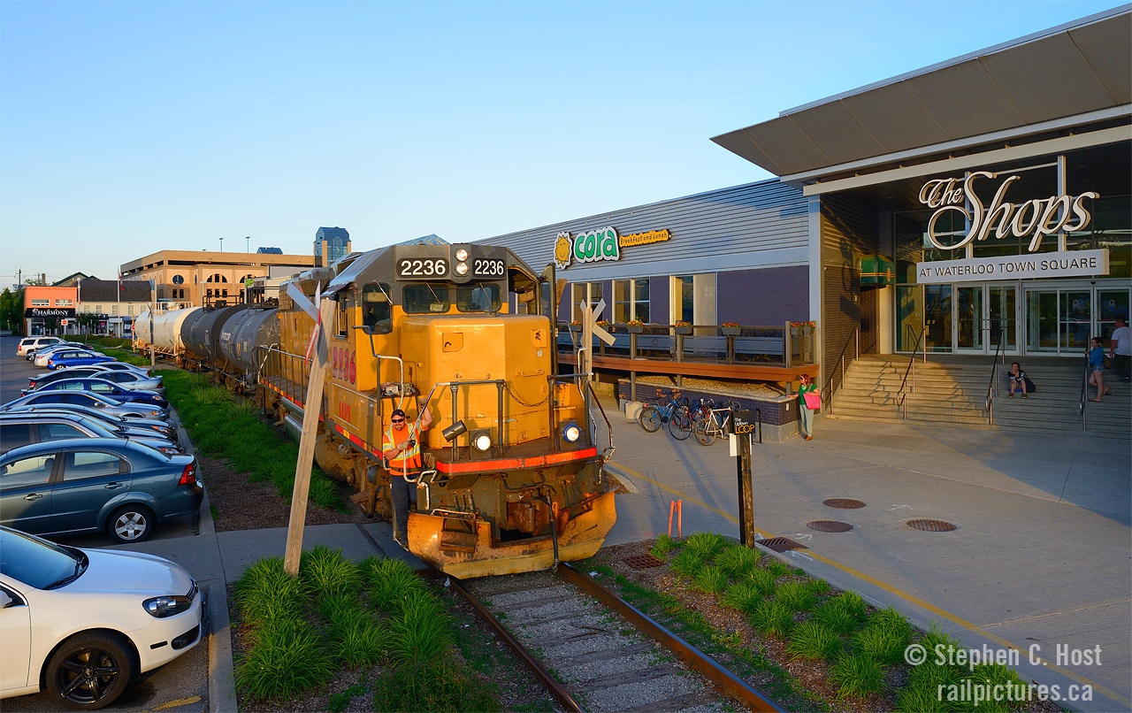 At the time this photo was taken, the ION LRT was a twinkle in the eyes of Regional Chair Ken Sieling, and the Waterloo spur ran right through the parking lot of the Waterloo Town Square mall where unsuspecting pedestrians and vehicles could find themselves too close to an active rail line. GEXR service on the Waterloo spur was four days a week and basically only in daylight when they departed early enough, and only on the longest days of the year, and it was about a 25% chance by my recollection.  Funny though, I had to move a shopping cart that was parked on the rails as my light was quickly diminishing and I didn't want any delay.... I wonder how the cart got there? hmmmmmmmmmmmmm... anyone know? This area is now a LRT station and has completely changed.
