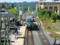 VIA Rail train 84 with P42DC 915 makes its station stop at Kitchener, Ontario on the Guelph Subdivision as a full platform of passengers await. Since this spring, the new VIA Siemens Charger/Venture sets have been predominantly assigned to 84 and 87, replacing the aging P42DC’s and the classic Budd coaches. 
