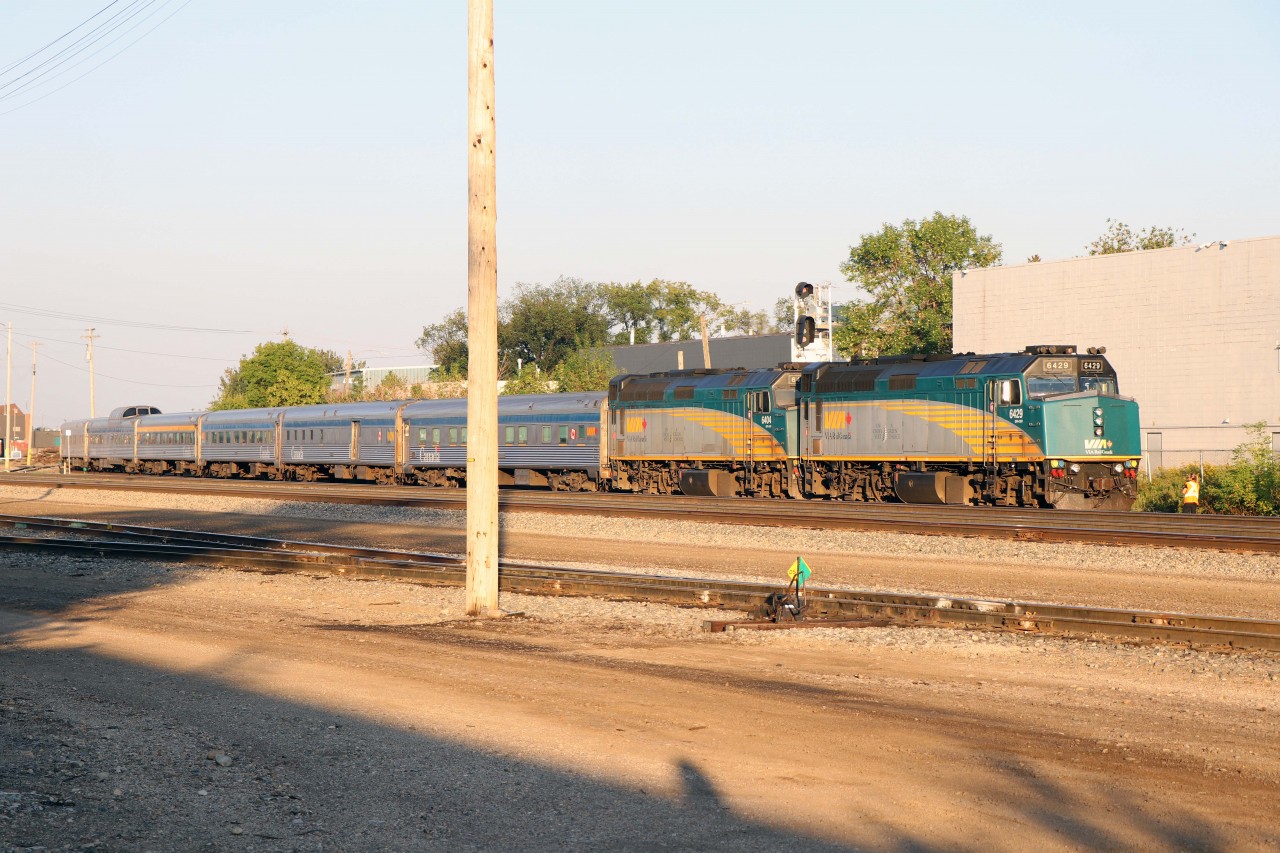 Two and a half days after leaving Toronto, VIA No. 1 has stopped at West Jct in Edmonton to drop off one of the Engineers before continuing a train-length past the eastward signal. The Engineer on the ground (visible on the far side of leading unit 6429) will give radio instructions to the locomotive engineer controlling the train as it backs into the Edmonton station. "The Canadian" had to wait on the Walker by-pass for hot container train 111 (which itself had to wait for 417 to leave and dodge an inbound 844). Before it even starts to shove, the VIA will be passed by another CN westbound (761). Just another day in CN's busy Edmonton terminal...