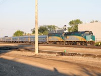Two and a half days after leaving Toronto, VIA No. 1 has stopped at West Jct in Edmonton to drop off one of the Engineers before continuing a train-length past the eastward signal. The Engineer on the ground (visible on the far side of leading unit 6429) will give radio instructions to the locomotive engineer controlling the train as it backs into the Edmonton station. "The Canadian" had to wait on the Walker by-pass for hot container train 111 (which itself had to wait for 417 to leave and dodge an inbound 844). Before it even starts to shove, the VIA will be passed by another CN westbound (761). Just another day in CN's busy Edmonton terminal...