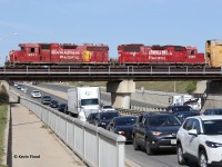 CPKC H70 does its usual switching in/around Maple Grove/Toyota plant as it passes over a busy Maple Grove Rd at the border of Kitchener and Cambridge. The train would proceed in reverse to switch the plant at Fountain St. Power is CP 3011-3099. Nice to see some older models working. There was a time when this crossing was at grade. A bridge was definitely a good call as this was a traffic nightmare. I wonder if anyone has any shots here when it was a level crossing.