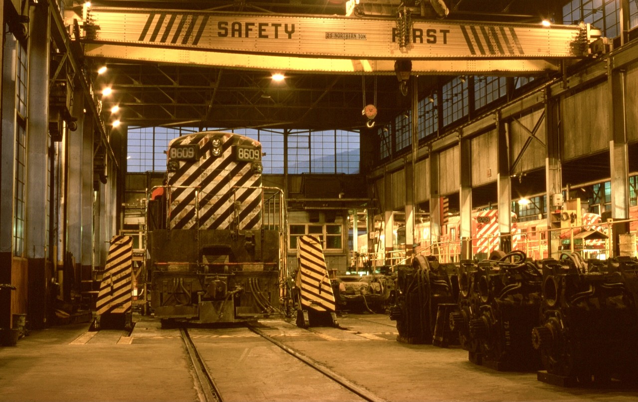By my blind luck timing in life at getting a vehicle and a driver’s licence, the last full year of Fairbanks-Morse power in southeast British Columbia was seen and photographed, with everyday scenes like this one in CP’s Nelson diesel shop well within reach.  Seen here on Friday 1974-10-18 in the evening, H16-44 CP 8609 is over the wheel exchange pit.

My grand plan was to transfer from Victoria roundhouse to Nelson to learn more about the F-Ms, but that evaporated in March 1975 when all Baldwin roadswitchers and most F-M power (except a few H24-66s for Alyth hump duty) were shut down.