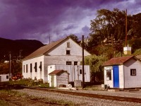 Lytton, on CN’s Ashcroft subdivision between Kamloops Jct. (0.0) and Boston Bar (125.5) and at the confluence of the Fraser and Thompson Rivers, originally had a Canadian Northern Pacific depot on the site of the modest VIA flagstop shelter (complete with the green-and-white flagstop signal) shown here on Friday 1980-05-23 looking eastward.  The substantial building nearby was a repeater station for telegraph and telephone signal circuits.