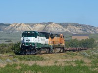 Having begun their day at 0330 in Assiniboia, this Great Western crew has many miles behind them as their short train navigates the Frenchman River Valley, late in the afternoon.