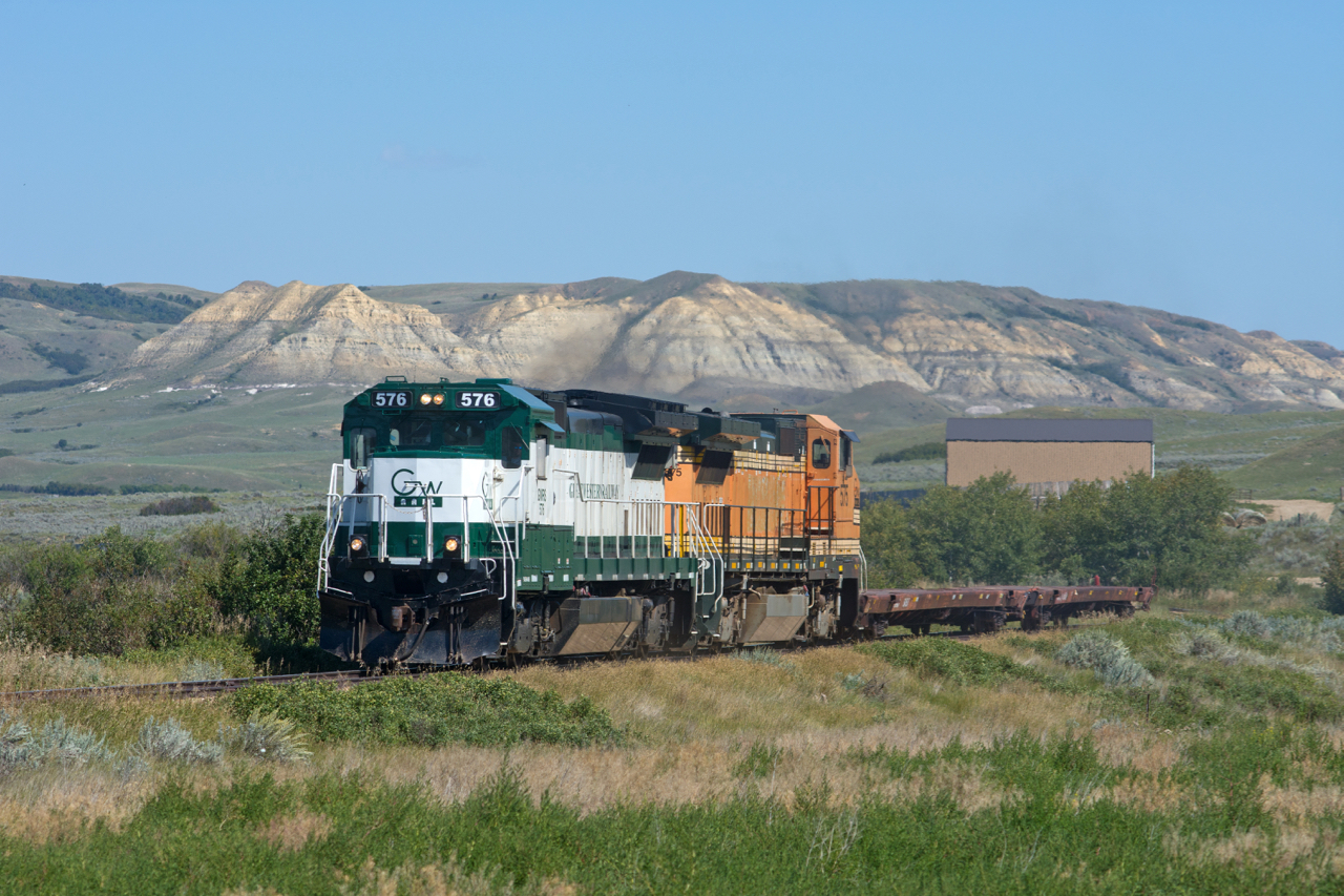 Having begun their day at 0330 in Assiniboia, this Great Western crew has many miles behind them as their short train navigates the Frenchman River Valley, late in the afternoon.