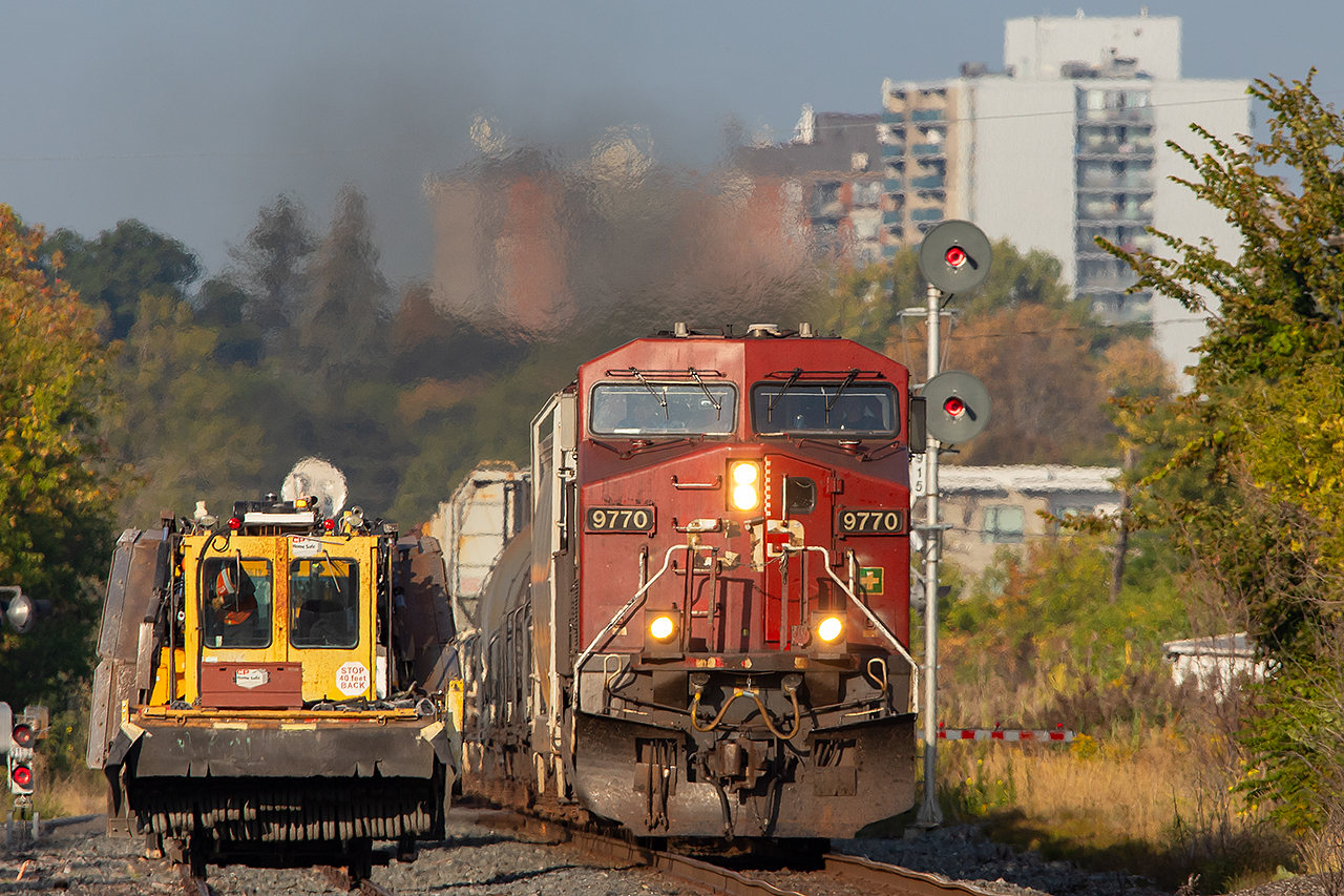 MOW equipment waits for an eastbound to pass through downtown Belleville before they enter the main.