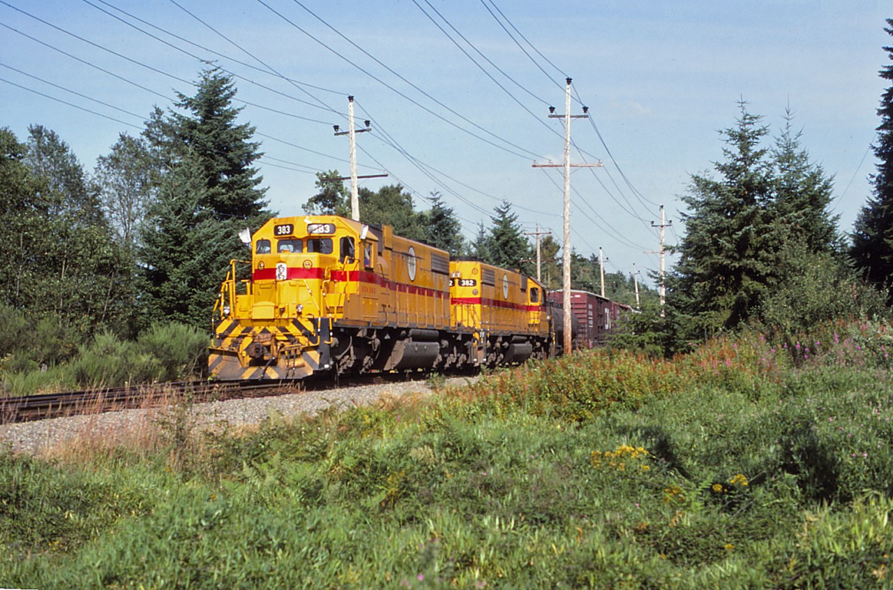 SD38-2 382 was one of two built in 1972 for BC Hydro by EMD in the U.S. (BC Hydro also received an SD38AC in 1971 and another SD38-2 in 1974--the latter is still in service on the Southern Railway of British Columbia.) On a pleasant day in the summer of 1984, we see both of the 1972 SDs leading a train past the Sperling siding in Langley--four years before BC Hydro's rail operations were sold to Itel (and later the Washington Group).